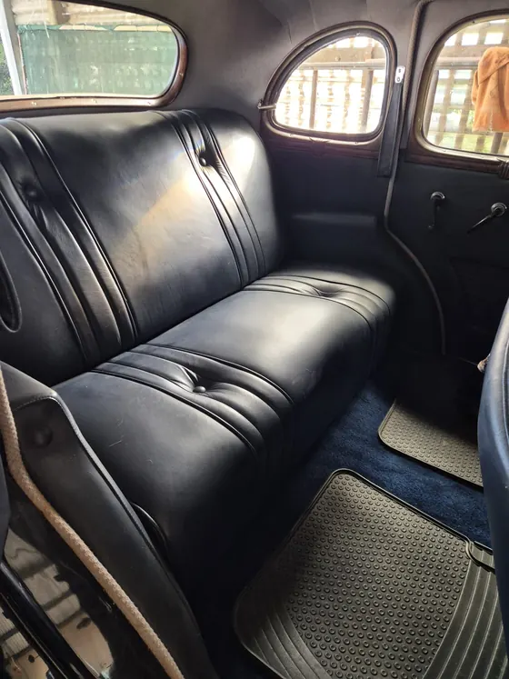 Black leather rear bench seat and rubber floor mats in the 1936 Oldsmobile F-37 sedan