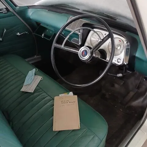 Dashboard, steering wheel and blue-green front bench seat of the 1962 Chrysler Valiant S Series