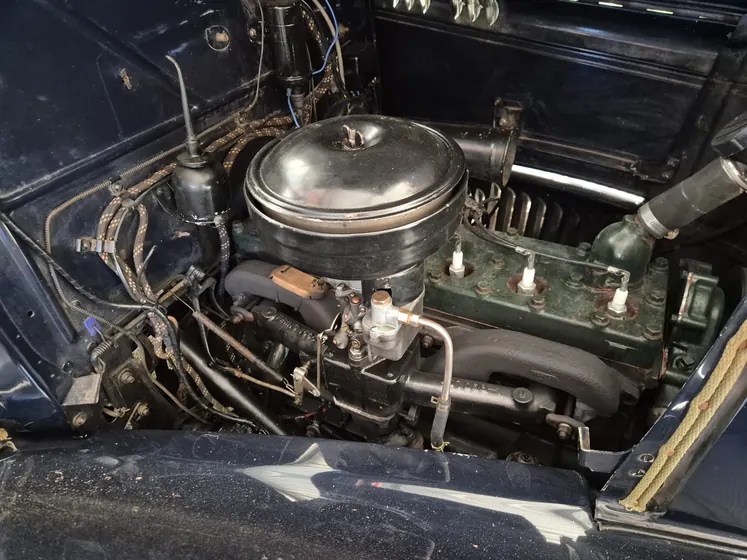 Engine bay of the 1936 Oldsmobile F-37 sedan showing the engine, air cleaner and carburettor