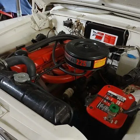 Engine bay of the 1962 Chrysler Valiant showing the red Super 225 Slant Six with its air cleaner