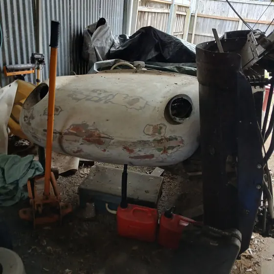 Side view of a fibreglass body section from the c1960 Goggomobil Dart, showing the original cream paint and lamp opening