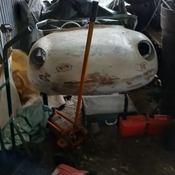 Front fibreglass body section of the c1960 Goggomobil Dart showing its headlamp openings and original paint