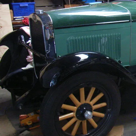Radiator shell, headlamp and timber-spoke front wheel of the restored c1928 Chevrolet Roadster