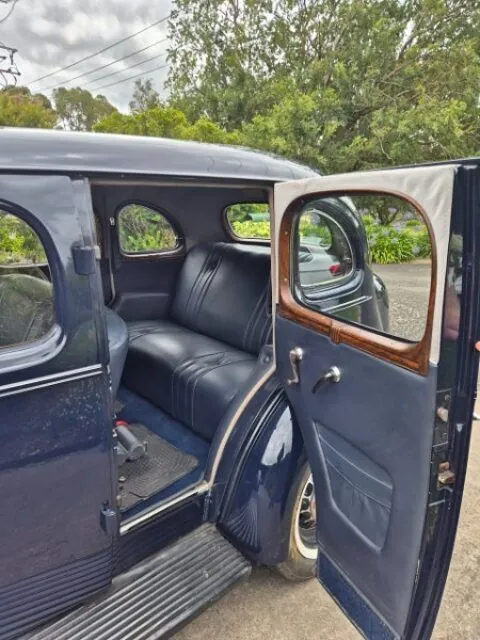 Rear door open on the 1936 Oldsmobile F-37 sedan showing the leather door card and running board