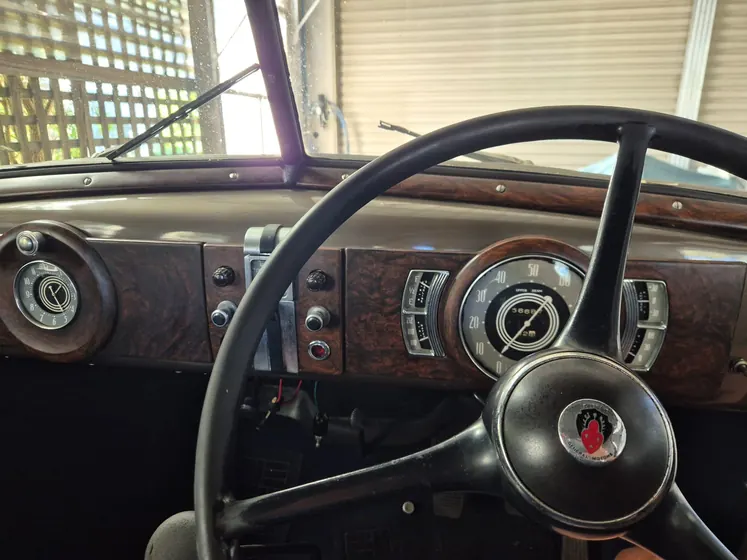 Woodgrain dashboard, instruments and steering wheel of the 1936 Oldsmobile F-37 sedan
